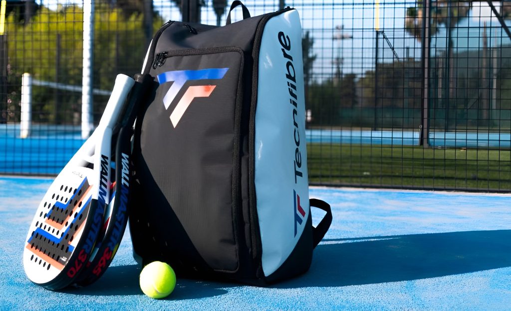 Tecnifibre Padel bag, padel rackets and padel ball on a padel court